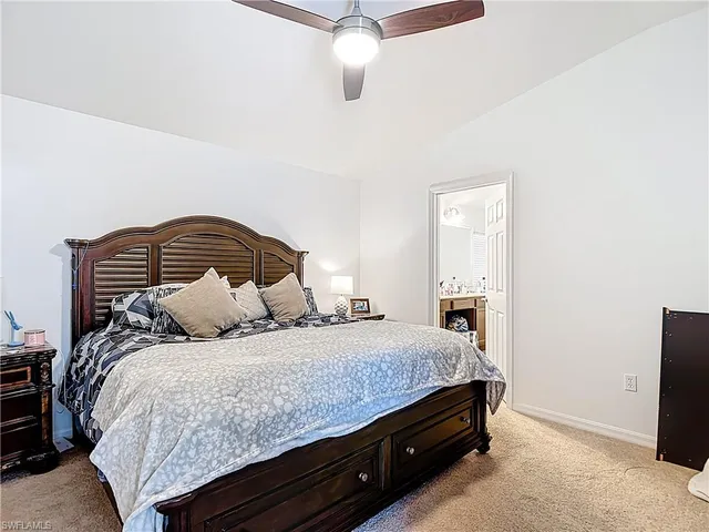 a bedroom with a bed and ceiling fan