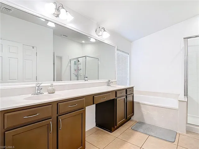 a bathroom with a sink vanity and mirror