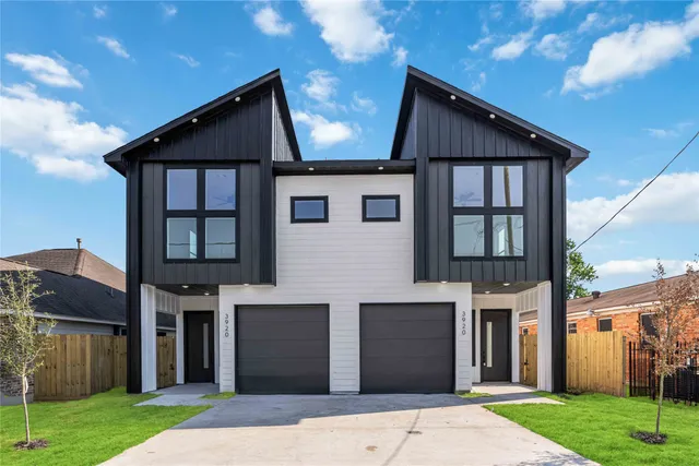 a front view of a house with a garden and yard