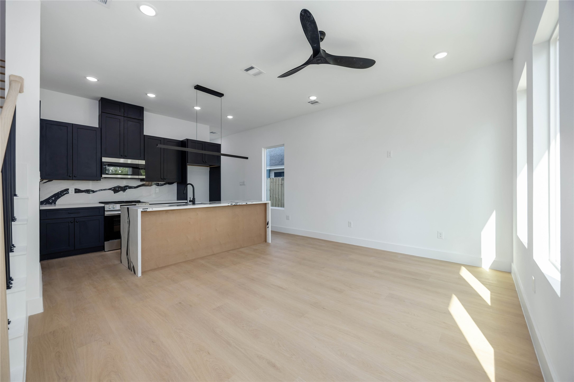 3920 Aledo Street, Unit AB Houston, TX 77051 - Photo 6 of 27 a large white kitchen with kitchen island a large counter top a stove a sink and a refrigerator