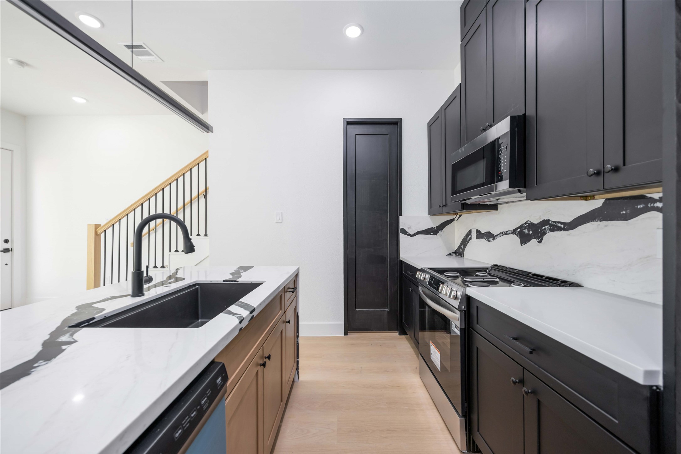 3920 Aledo Street, Unit AB Houston, TX 77051 - Photo 10 of 27 a kitchen with stainless steel appliances granite countertop a sink stove and refrigerator