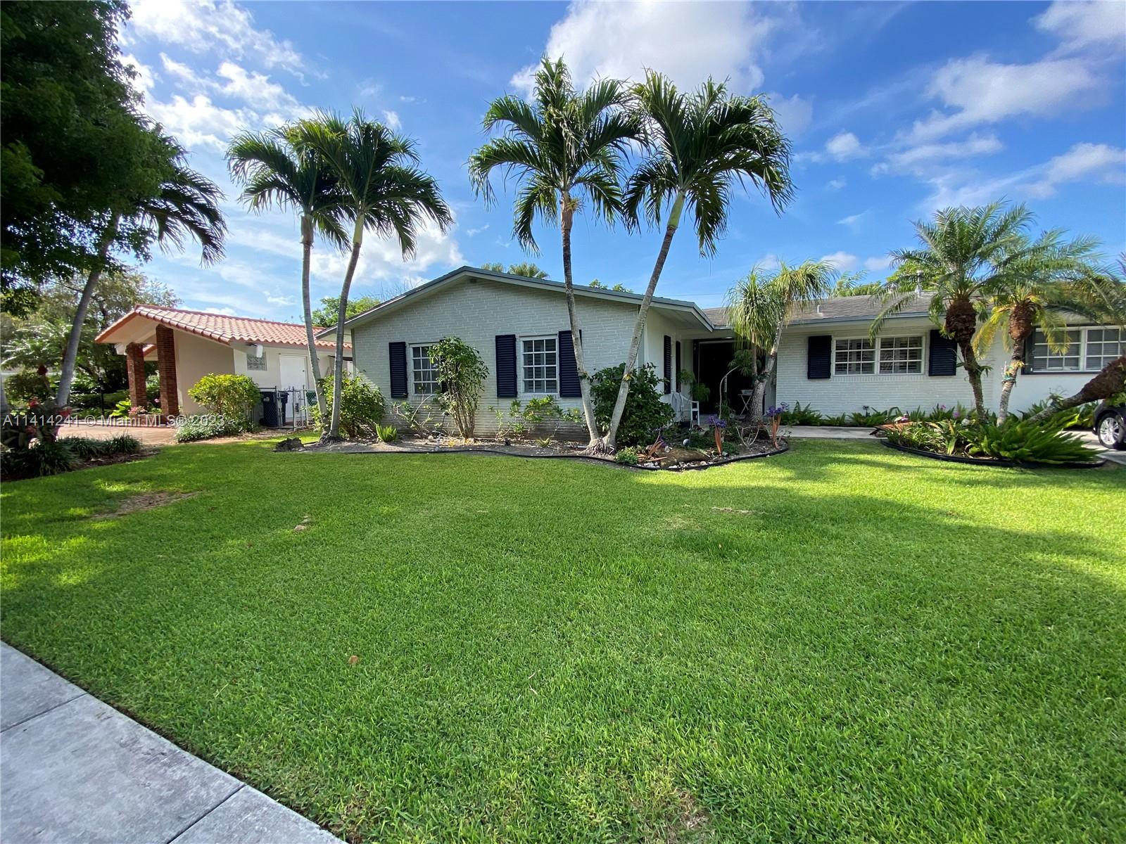 9020 Southwest 187th Terrace Cutler Bay, FL 33157 - Photo 1 of 55 a front view of house with yard and green space
