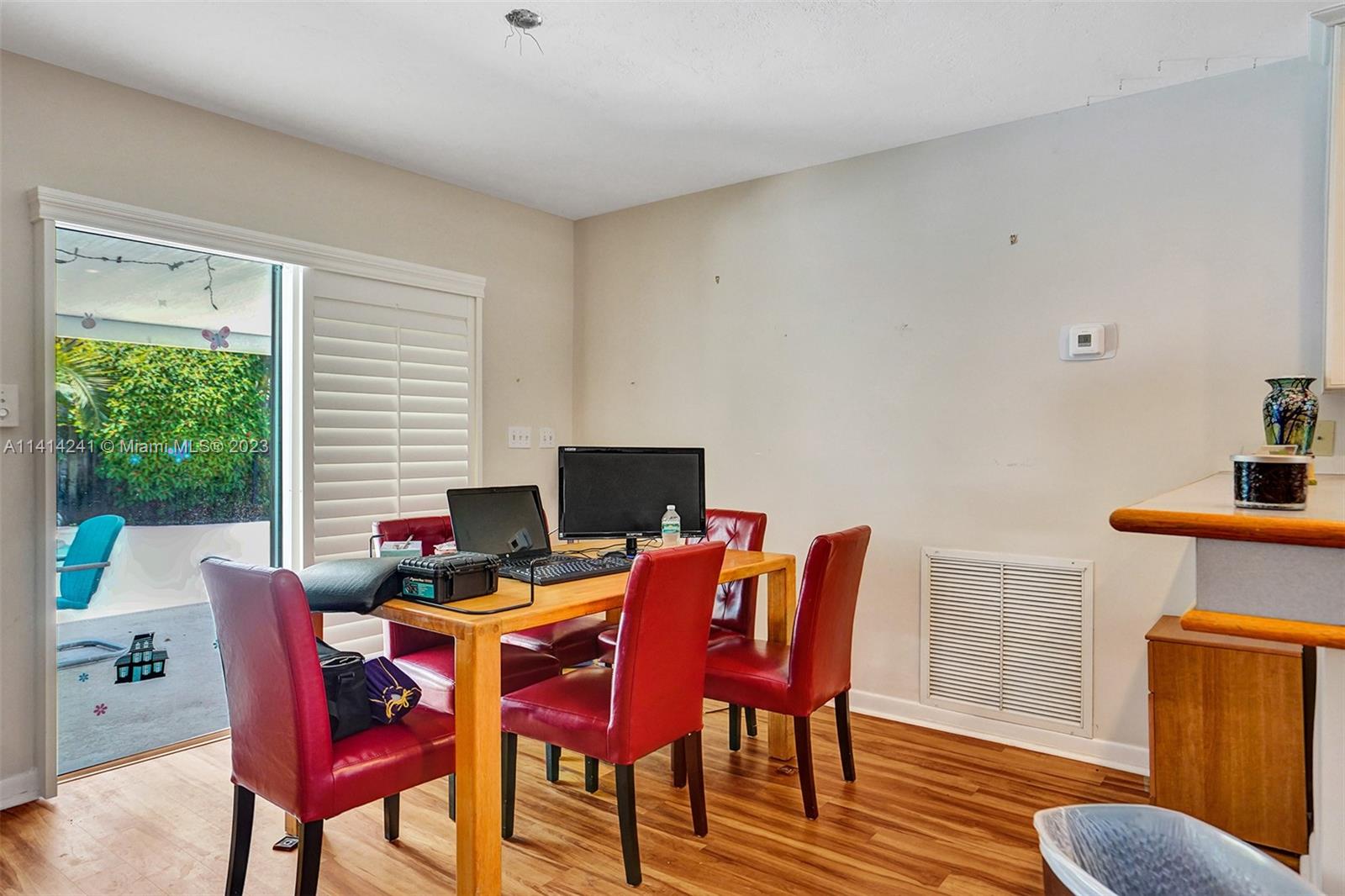 9020 Southwest 187th Terrace Cutler Bay, FL 33157 - Photo 13 of 55 a view of a dining room with furniture and wooden floor