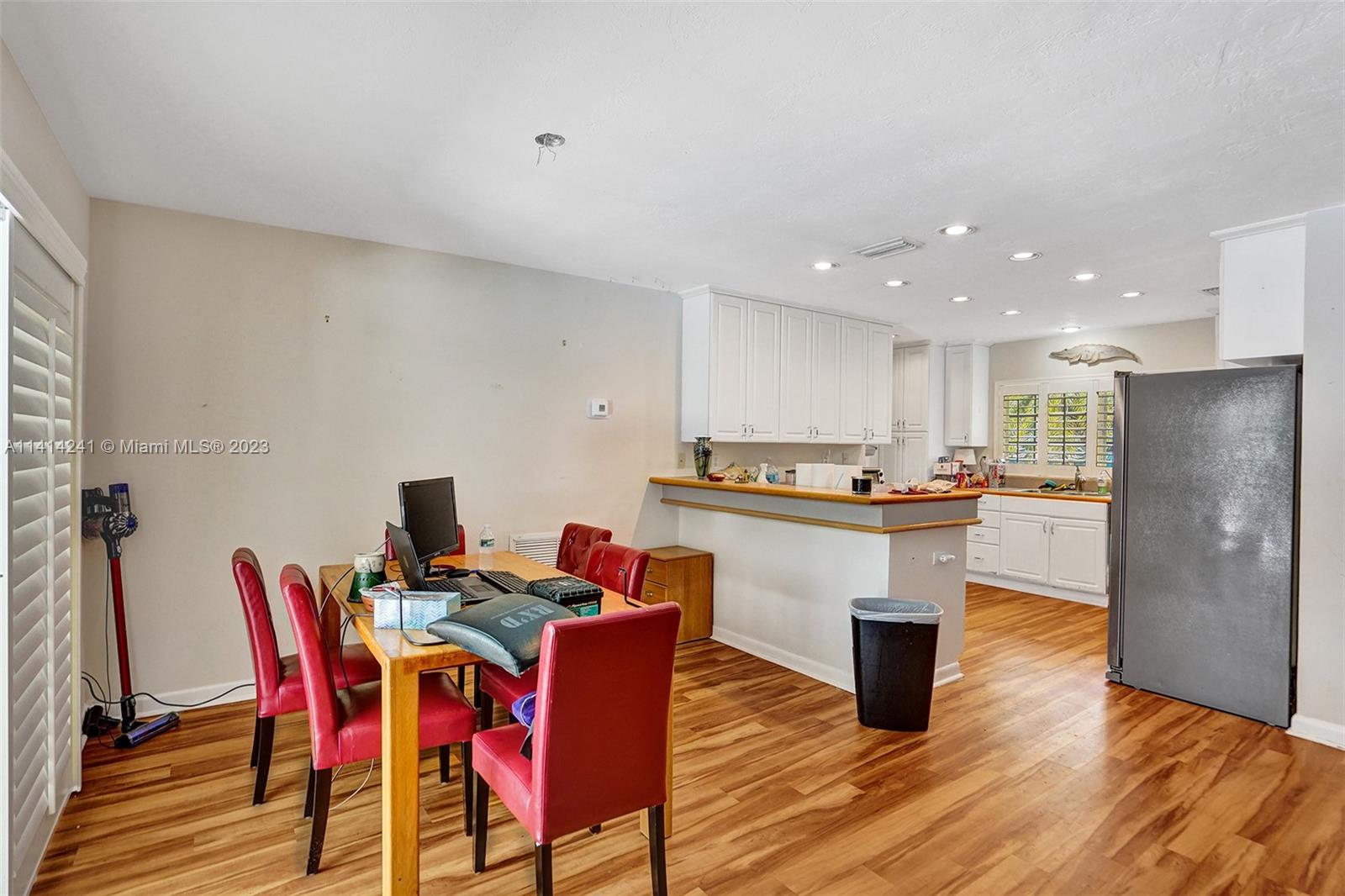9020 Southwest 187th Terrace Cutler Bay, FL 33157 - Photo 15 of 55 a kitchen with stainless steel appliances kitchen island granite countertop a kitchen island a stove a table and chairs