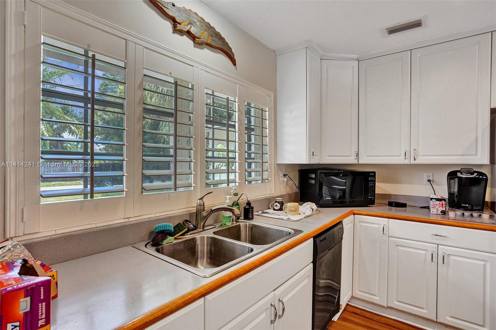 9020 Southwest 187th Terrace Cutler Bay, FL 33157 - Photo 16 of 55 a kitchen that has a sink and a cabinets