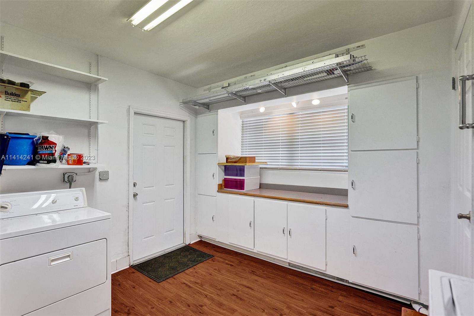 9020 Southwest 187th Terrace Cutler Bay, FL 33157 - Photo 19 of 55 a room view with a wooden floor and cabinets
