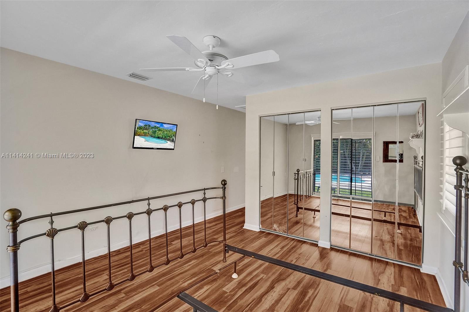 9020 Southwest 187th Terrace Cutler Bay, FL 33157 - Photo 24 of 55 a living room with hardwood floor and a ceiling fan