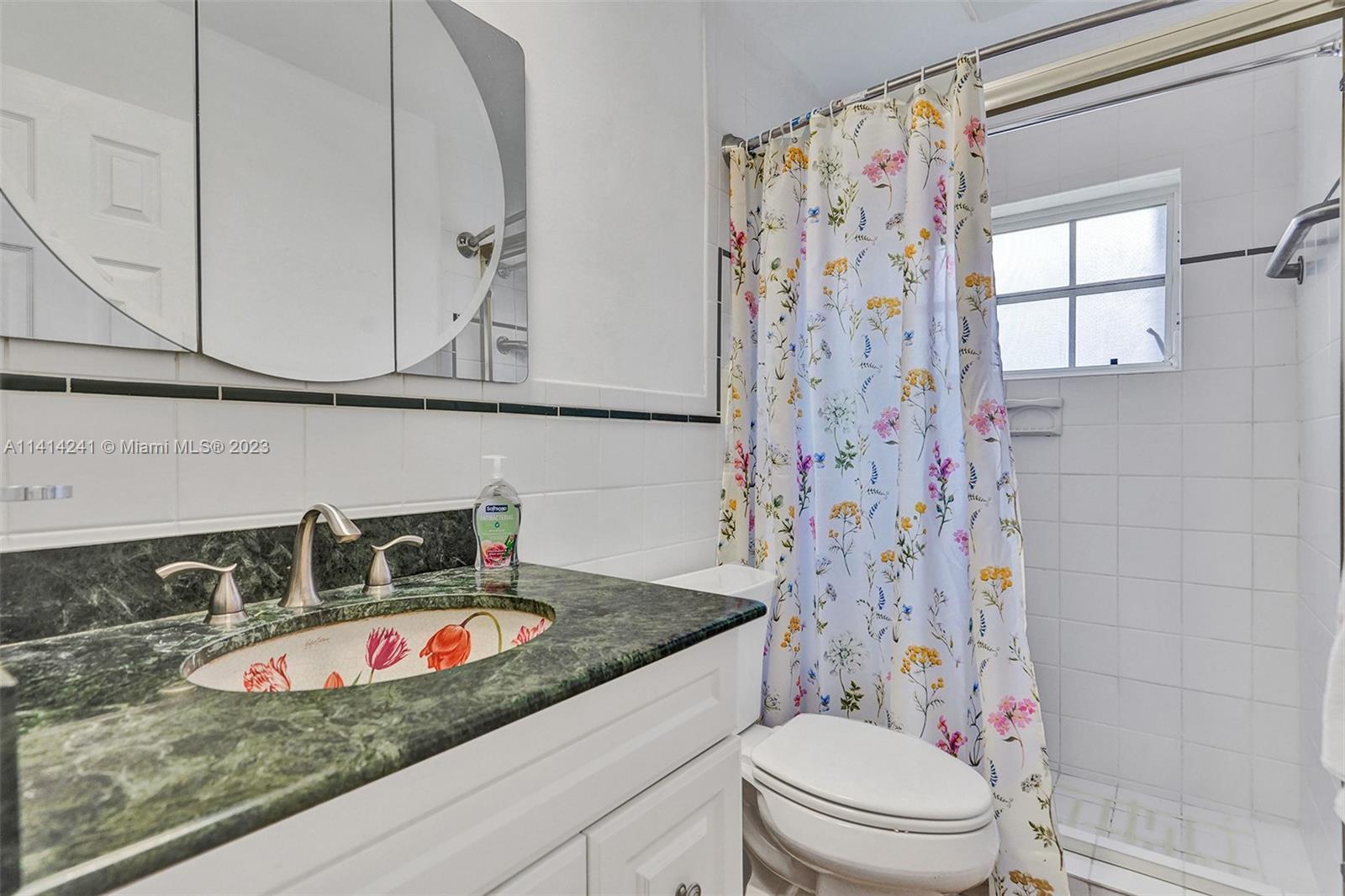 9020 Southwest 187th Terrace Cutler Bay, FL 33157 - Photo 25 of 55 a bathroom with a granite countertop sink and a mirror