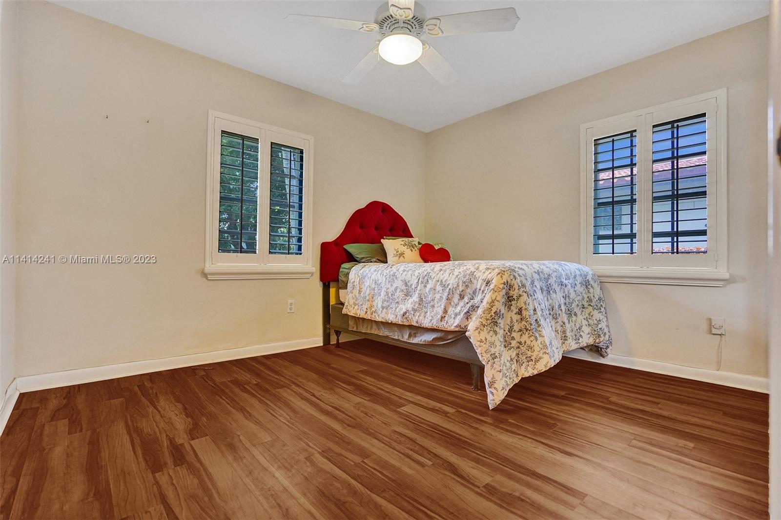 9020 Southwest 187th Terrace Cutler Bay, FL 33157 - Photo 26 of 55 a bed sitting in a bedroom next to a window