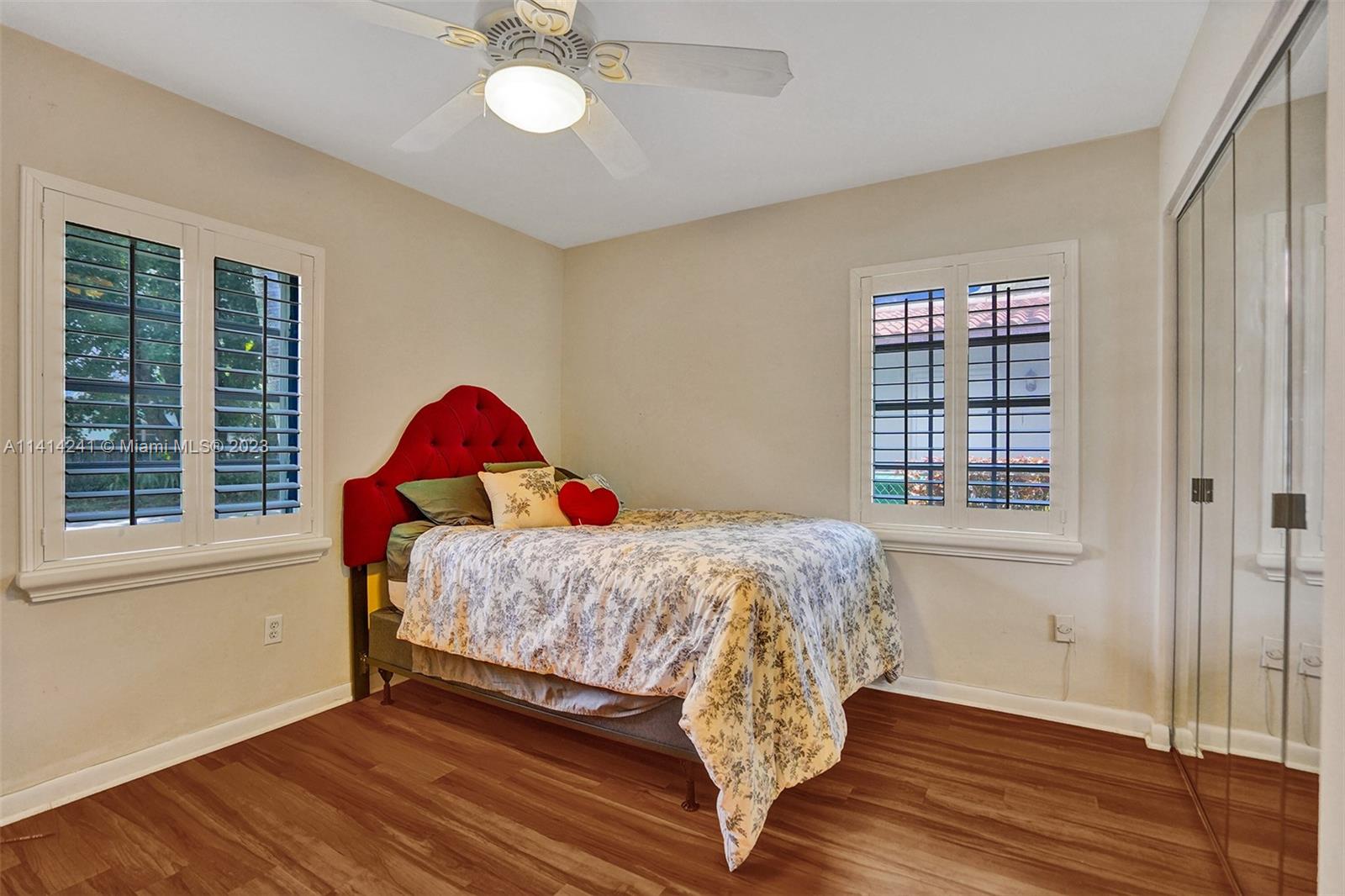 9020 Southwest 187th Terrace Cutler Bay, FL 33157 - Photo 27 of 55 a bed sitting in a bedroom next to a window