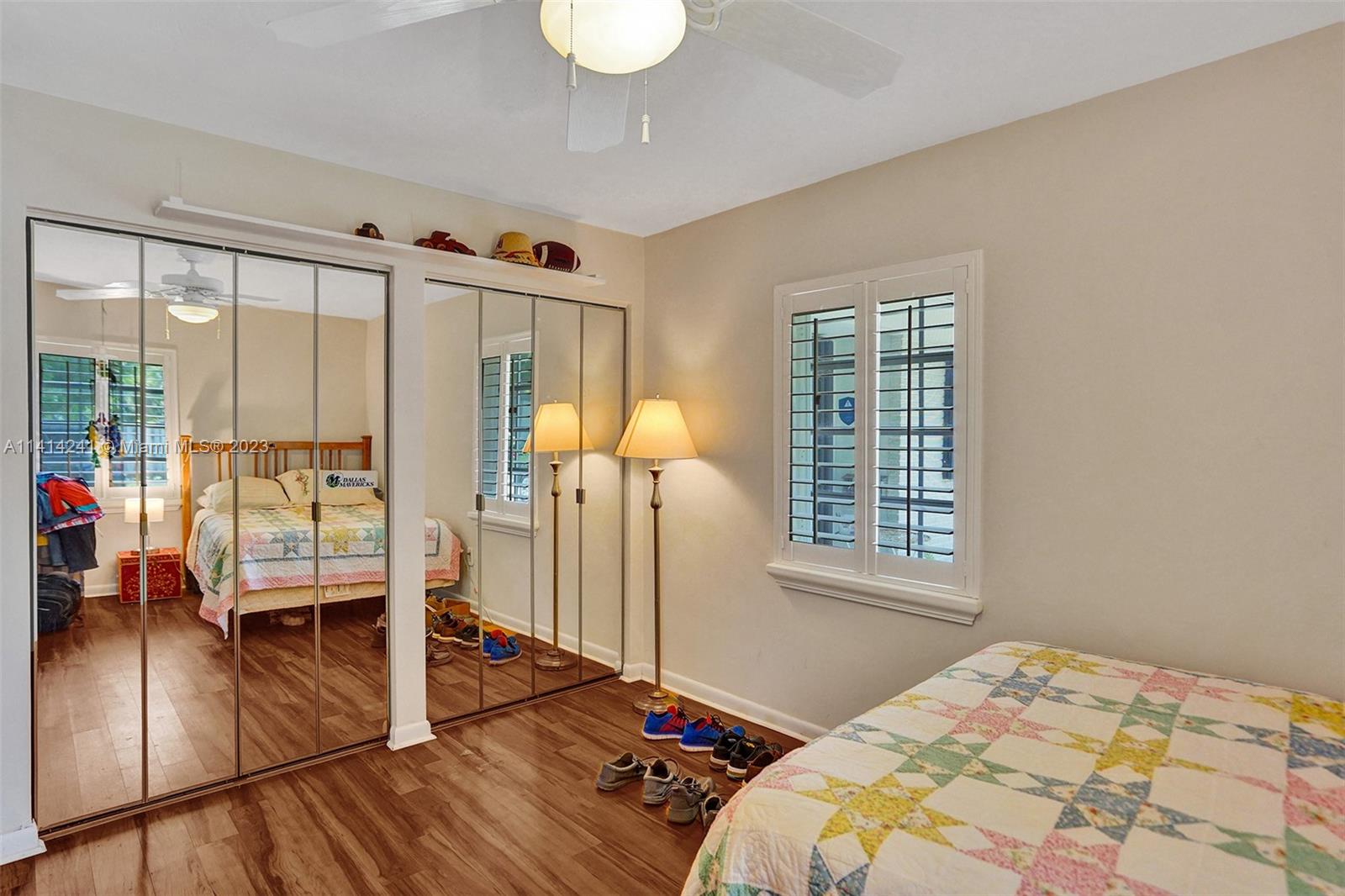 9020 Southwest 187th Terrace Cutler Bay, FL 33157 - Photo 30 of 55 a bedroom with a bed and glass door