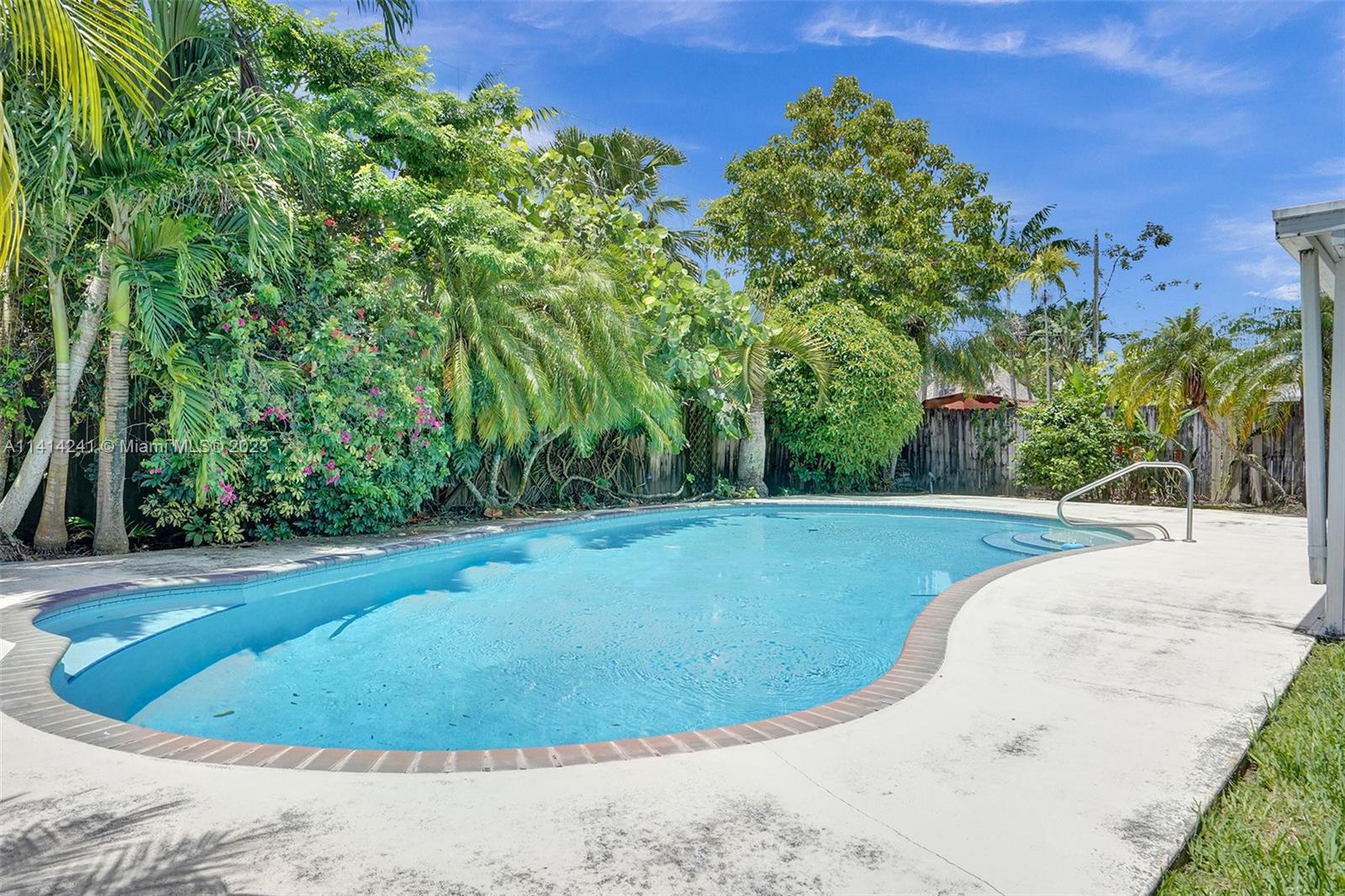 9020 Southwest 187th Terrace Cutler Bay, FL 33157 - Photo 3 of 55 a view of a swimming pool with a yard