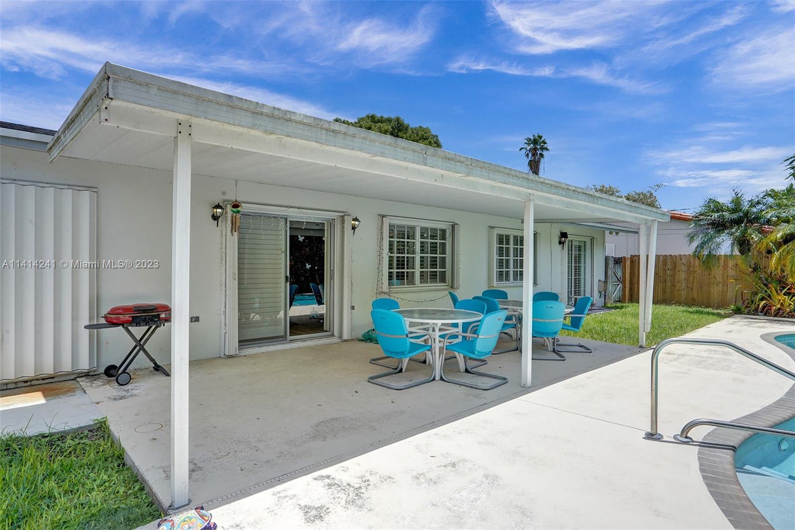 9020 Southwest 187th Terrace Cutler Bay, FL 33157 - Photo 37 of 55 a view of a house with backyard sitting area and porch