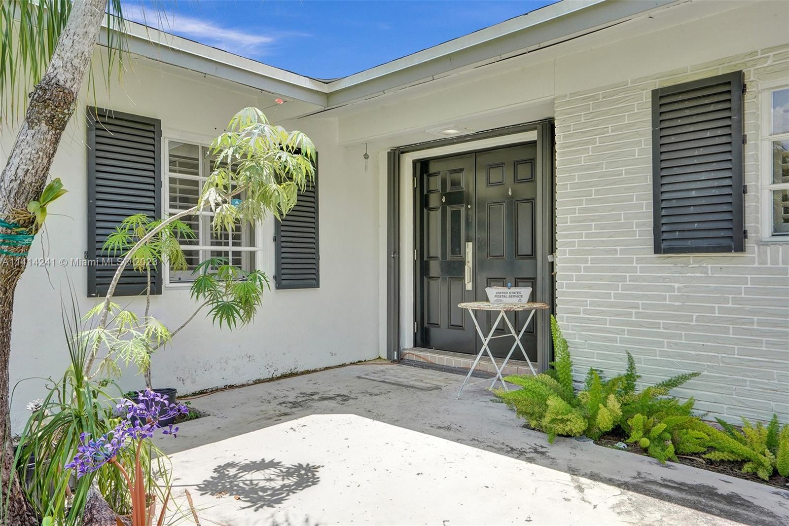 9020 Southwest 187th Terrace Cutler Bay, FL 33157 - Photo 50 of 55 a front view of a house with a porch