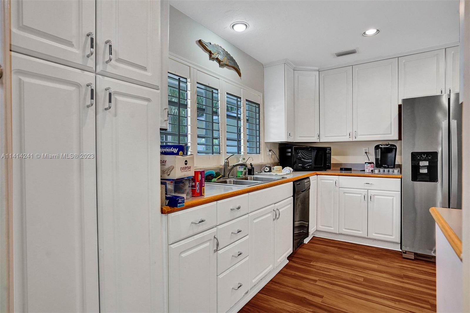 9020 Southwest 187th Terrace Cutler Bay, FL 33157 - Photo 5 of 55 a kitchen with white cabinets and white appliances