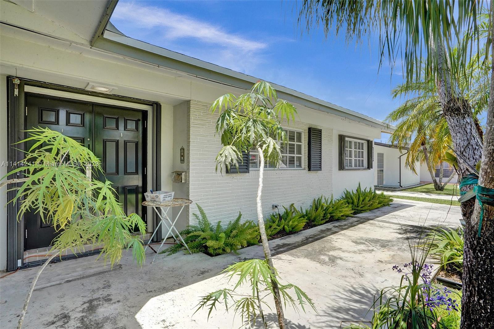 9020 Southwest 187th Terrace Cutler Bay, FL 33157 - Photo 51 of 55 a front view of a house with a yard