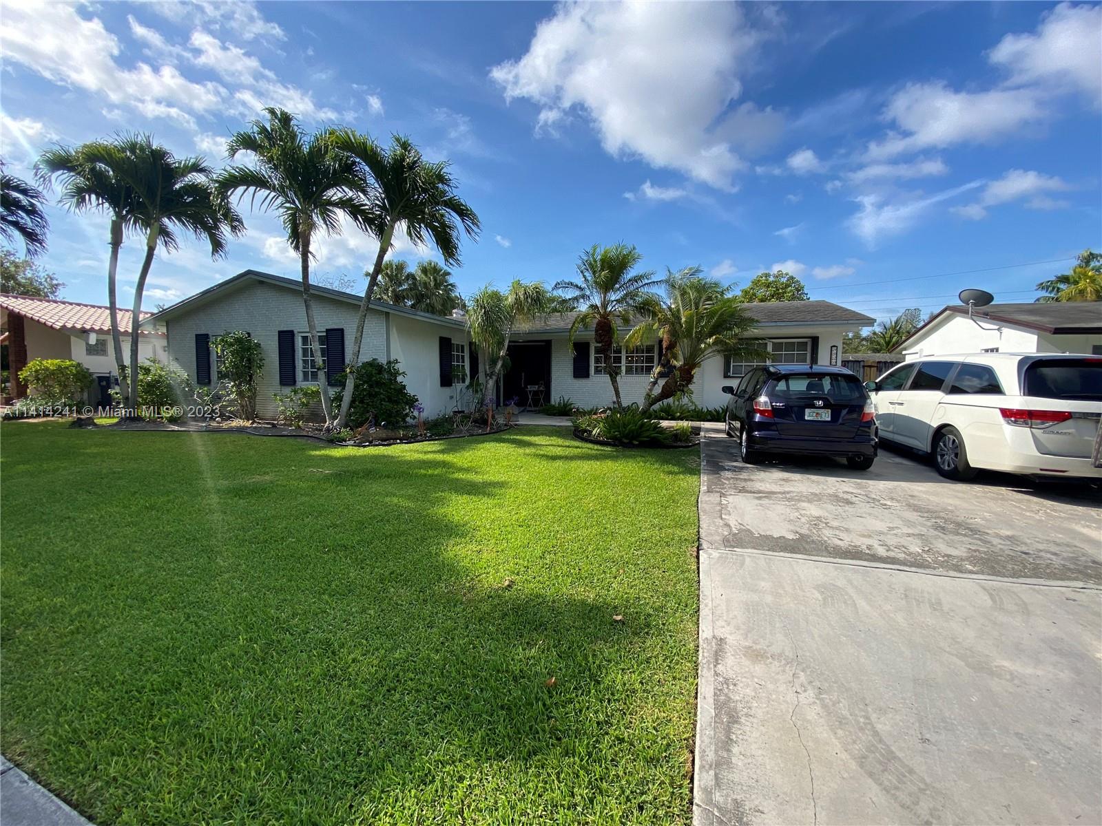 9020 Southwest 187th Terrace Cutler Bay, FL 33157 - Photo 54 of 55 a front view of a house with garden