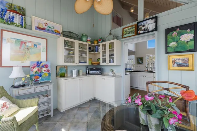 a living room with furniture and flowers