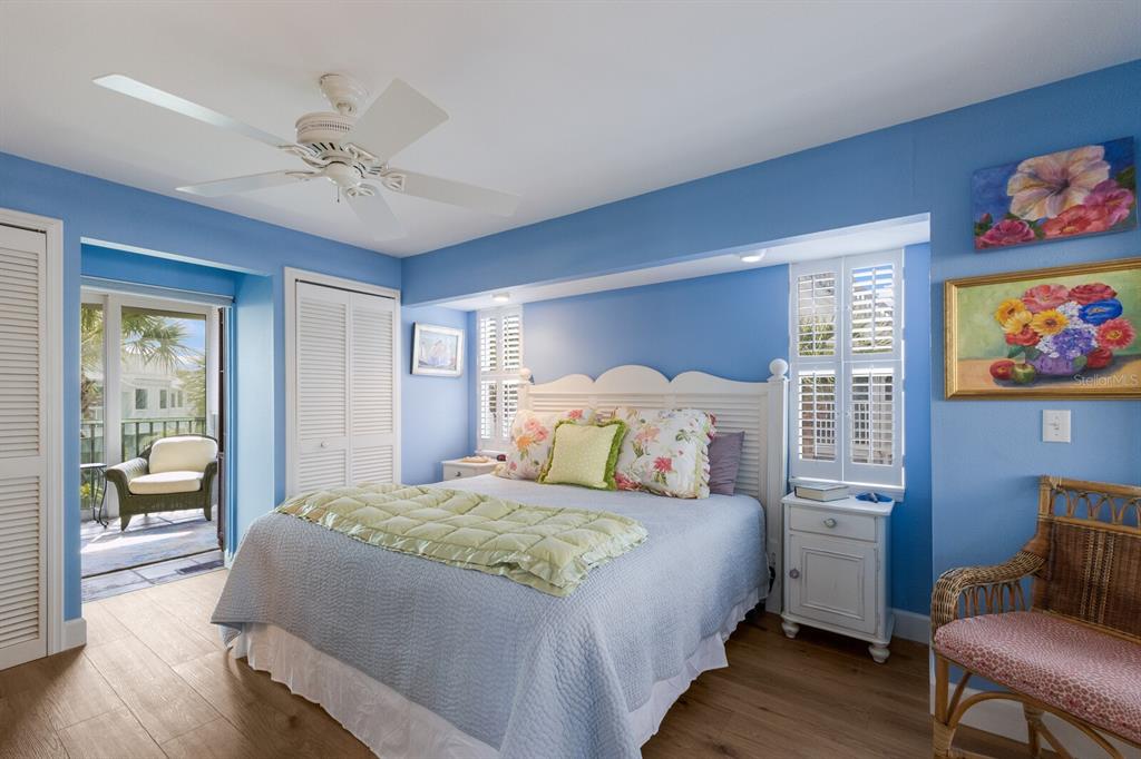 5000 Gasparilla Road, Unit VH37 Boca Grande, FL 33921 - Photo 18 of 54 a bedroom with a bed and a chandelier