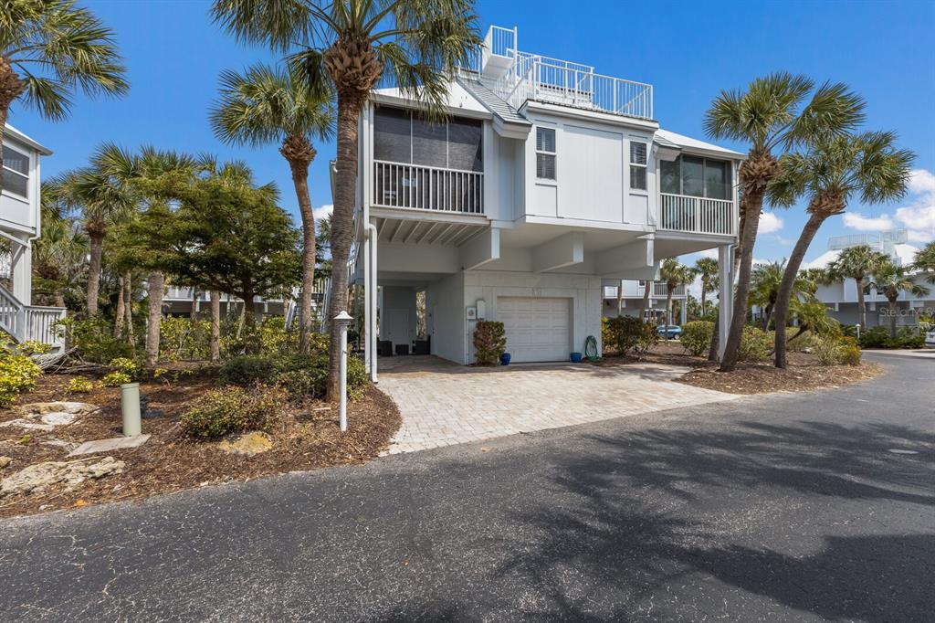 5000 Gasparilla Road, Unit VH37 Boca Grande, FL 33921 - Photo 2 of 54 a view of a house with a yard