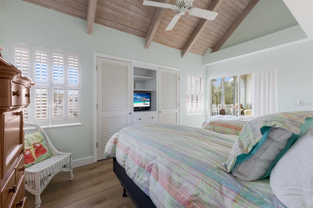 5000 Gasparilla Road, Unit VH37 Boca Grande, FL 33921 - Photo 22 of 54 a bedroom with a bed and wooden floor