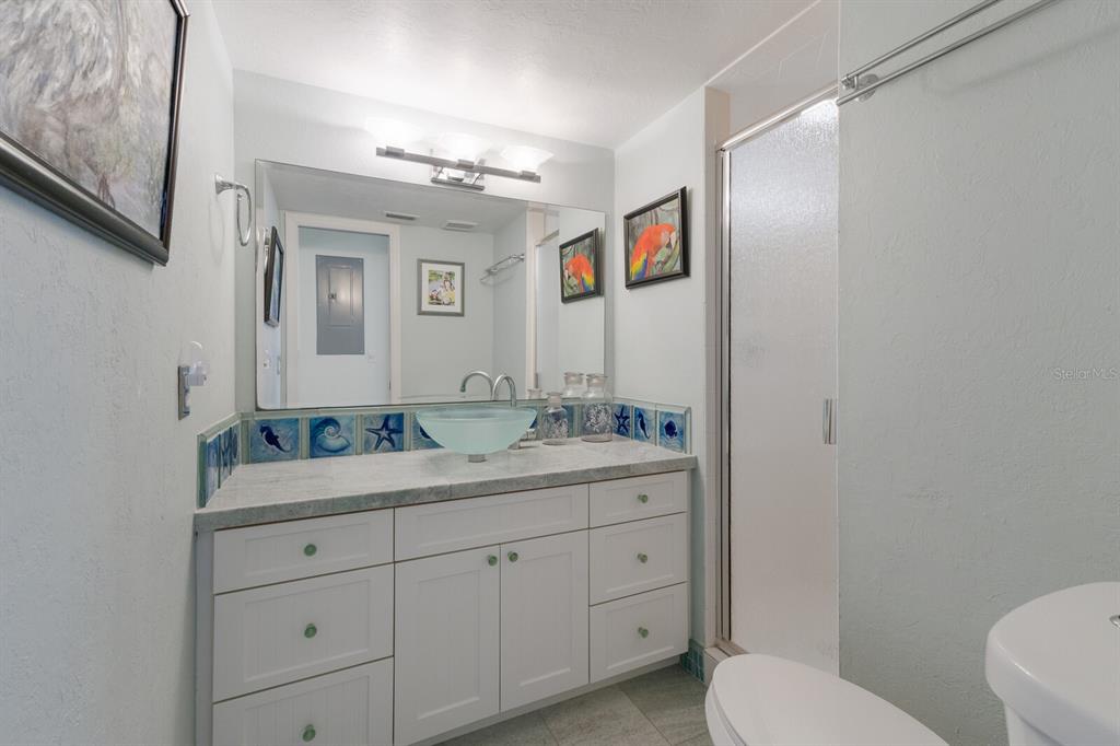 5000 Gasparilla Road, Unit VH37 Boca Grande, FL 33921 - Photo 23 of 54 a bathroom with a toilet a sink and mirror