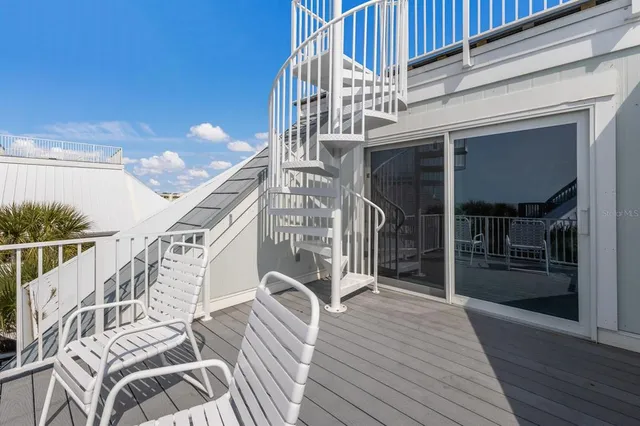 a view of a balcony with a yard
