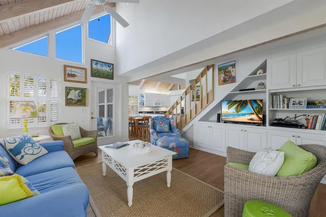 a living room with furniture fireplace and a large window