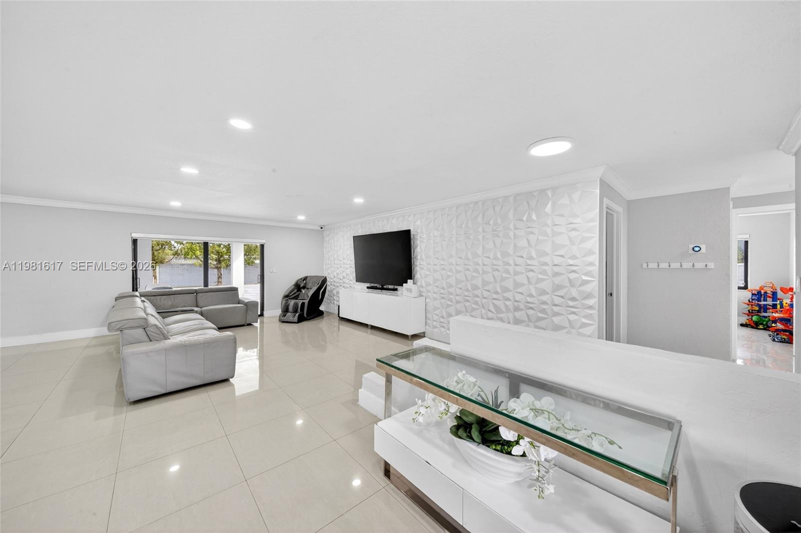 11951 Southwest 120th Terrace Miami, FL 33186 - Photo 12 of 55 a living room with furniture and a flat screen tv