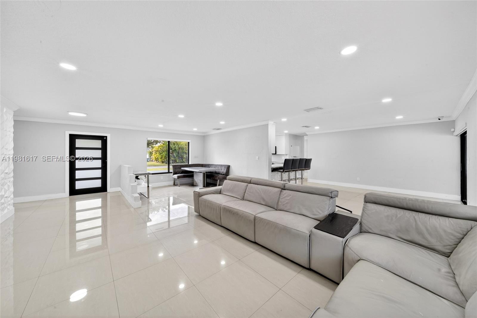 11951 Southwest 120th Terrace Miami, FL 33186 - Photo 13 of 55 a living room with furniture a wooden floor and a kitchen