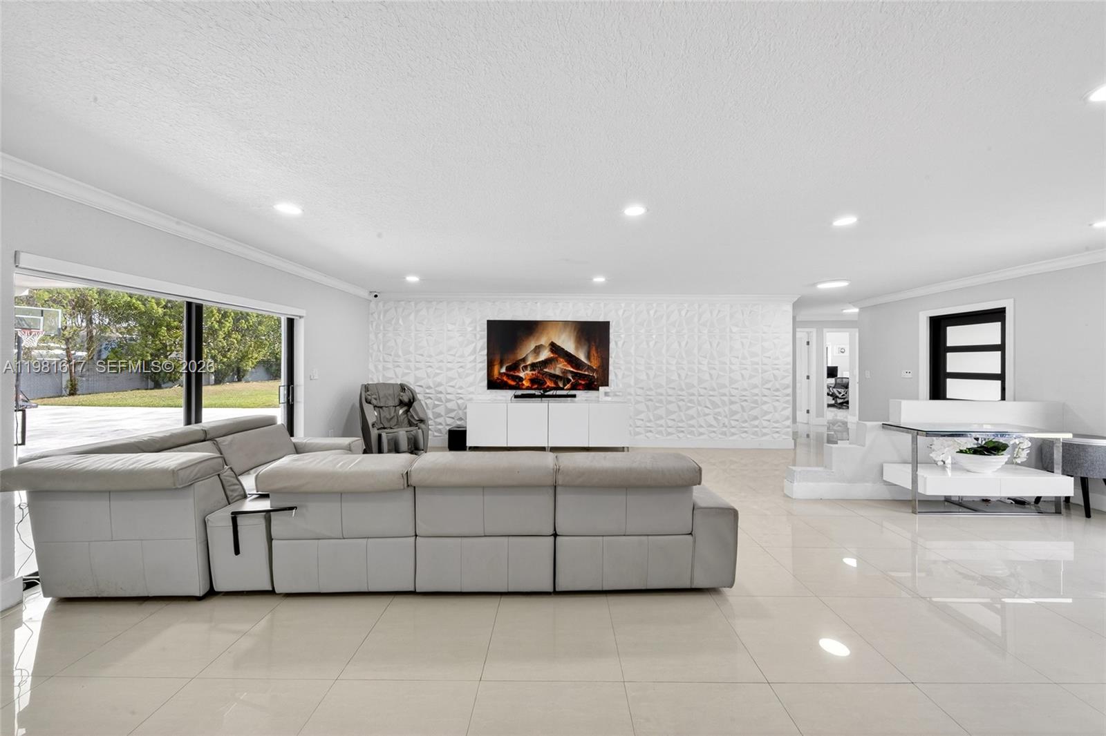11951 Southwest 120th Terrace Miami, FL 33186 - Photo 16 of 55 a living room with furniture and a large window
