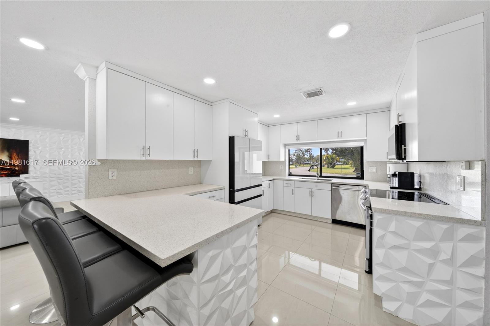 11951 Southwest 120th Terrace Miami, FL 33186 - Photo 18 of 55 a kitchen with stainless steel appliances kitchen island sink refrigerator and microwave