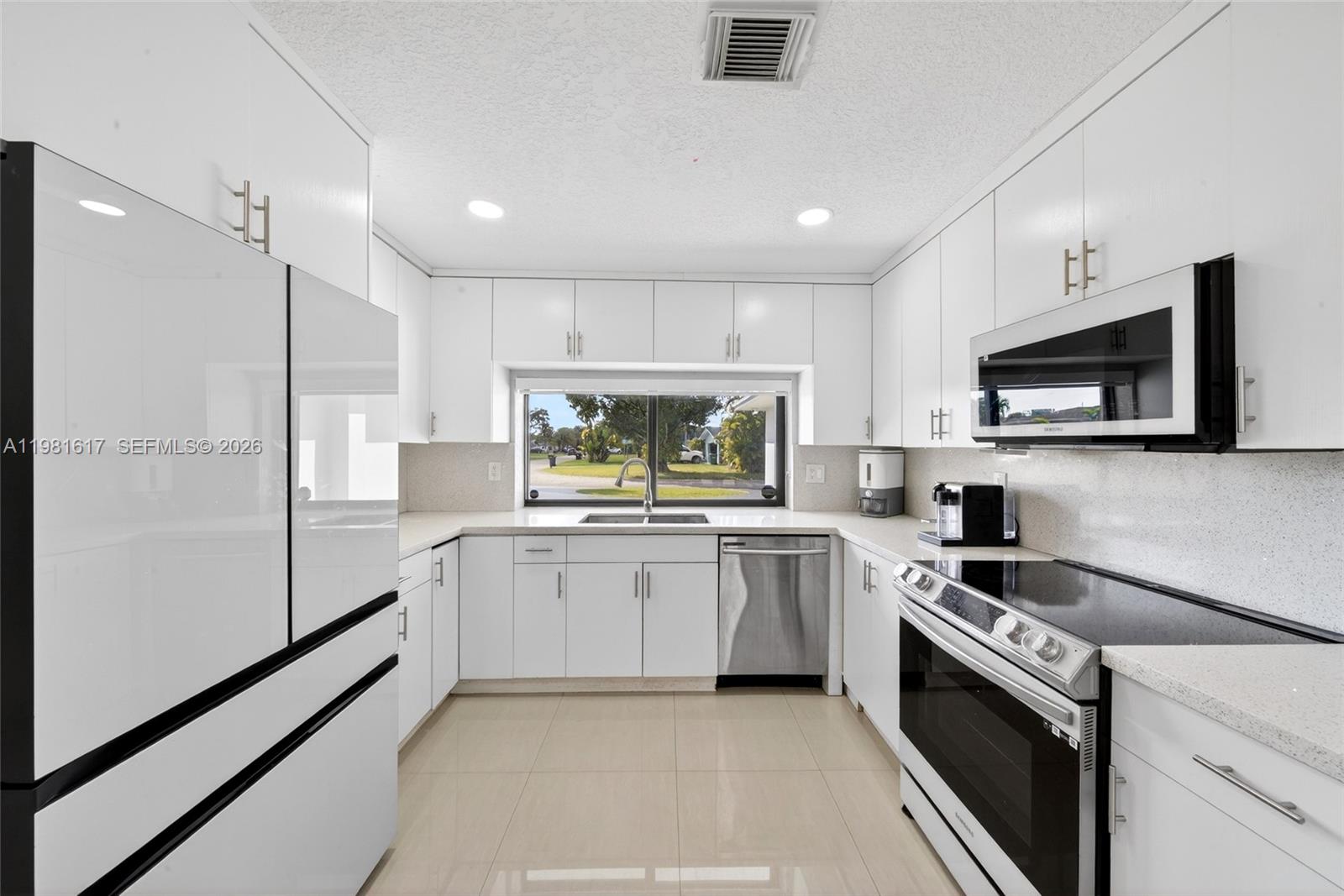11951 Southwest 120th Terrace Miami, FL 33186 - Photo 20 of 55 a kitchen with white cabinets and appliances