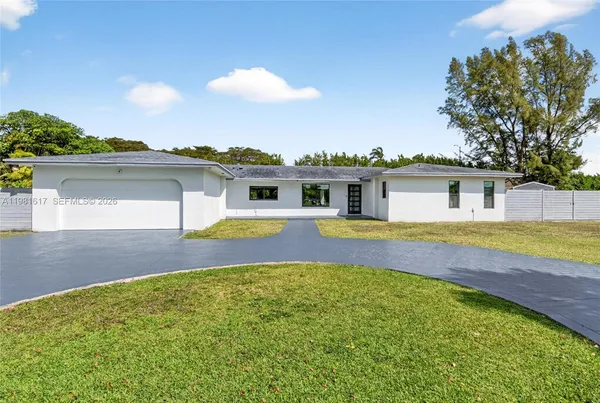 a view of a house with swimming pool and a yard
