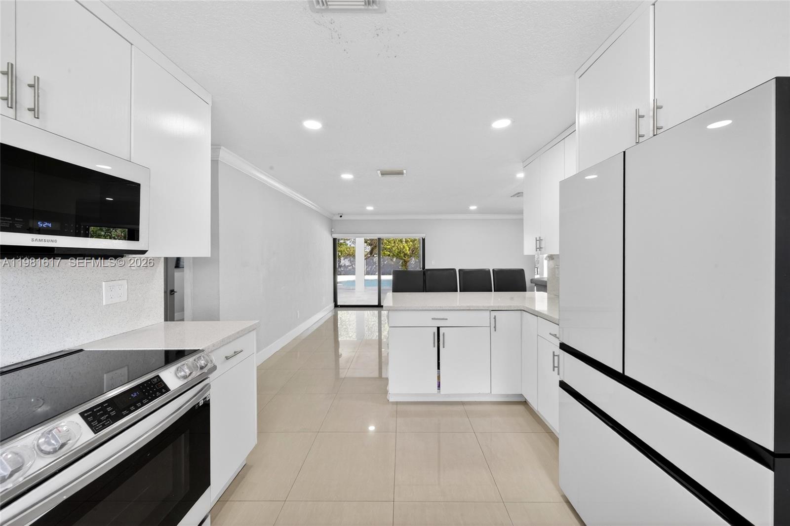 11951 Southwest 120th Terrace Miami, FL 33186 - Photo 21 of 55 a large kitchen with a large counter top stainless steel appliances and cabinets