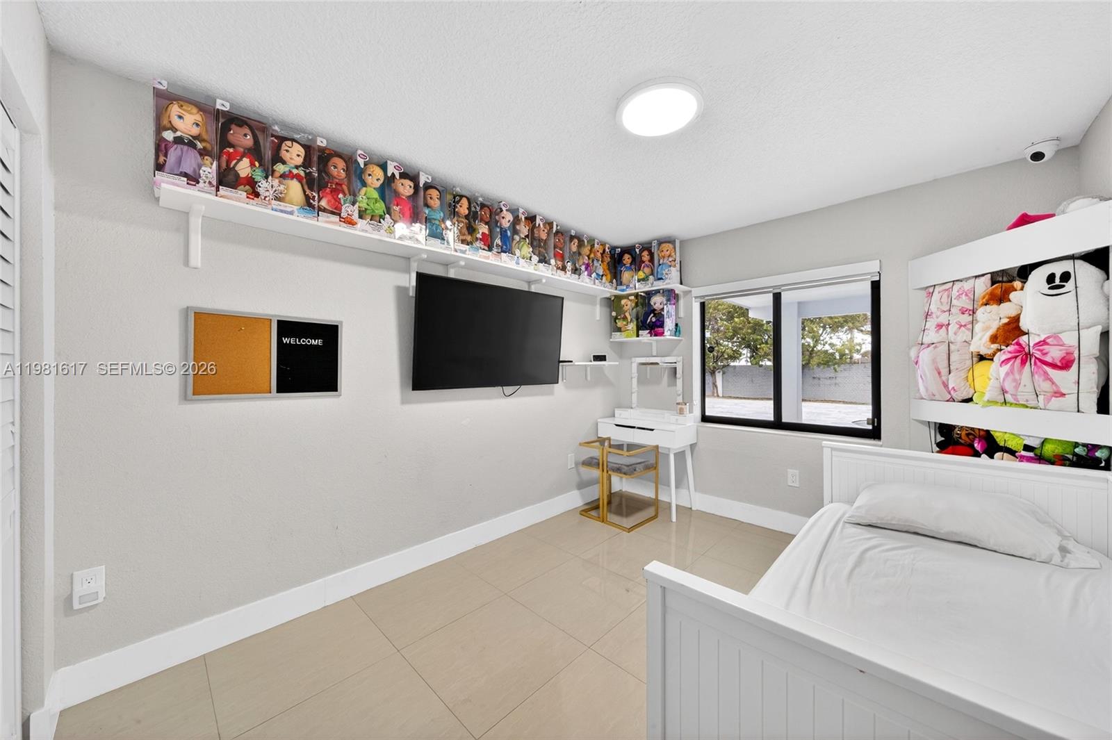 11951 Southwest 120th Terrace Miami, FL 33186 - Photo 27 of 55 a living room with furniture and a flat screen tv