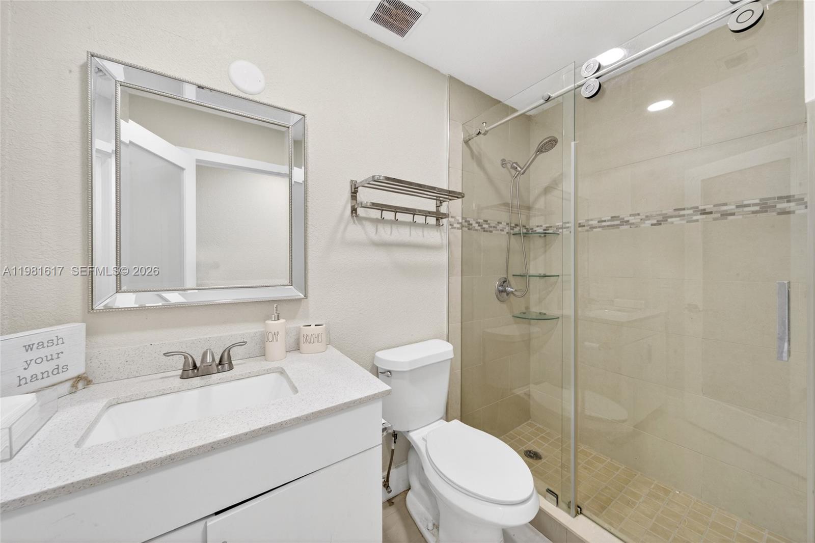 11951 Southwest 120th Terrace Miami, FL 33186 - Photo 29 of 55 a bathroom with a sink vanity granite toilet and shower