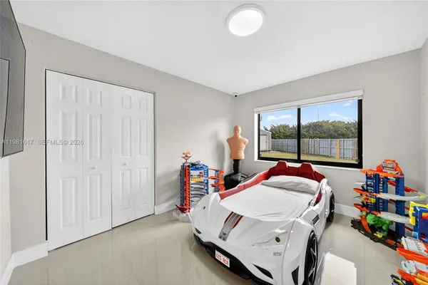 a bedroom with a bed and white cabinets