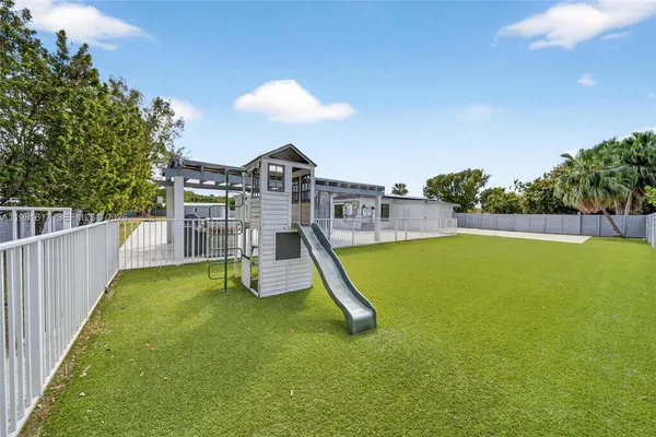 a view of house with swimming pool and sitting area