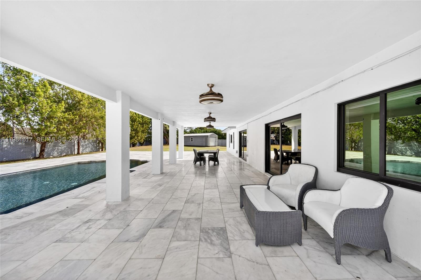 11951 Southwest 120th Terrace Miami, FL 33186 - Photo 48 of 55 a dining room with furniture and large windows