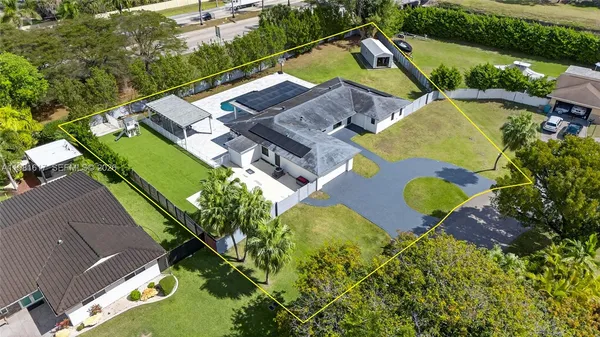 an aerial view of a house with a swimming pool