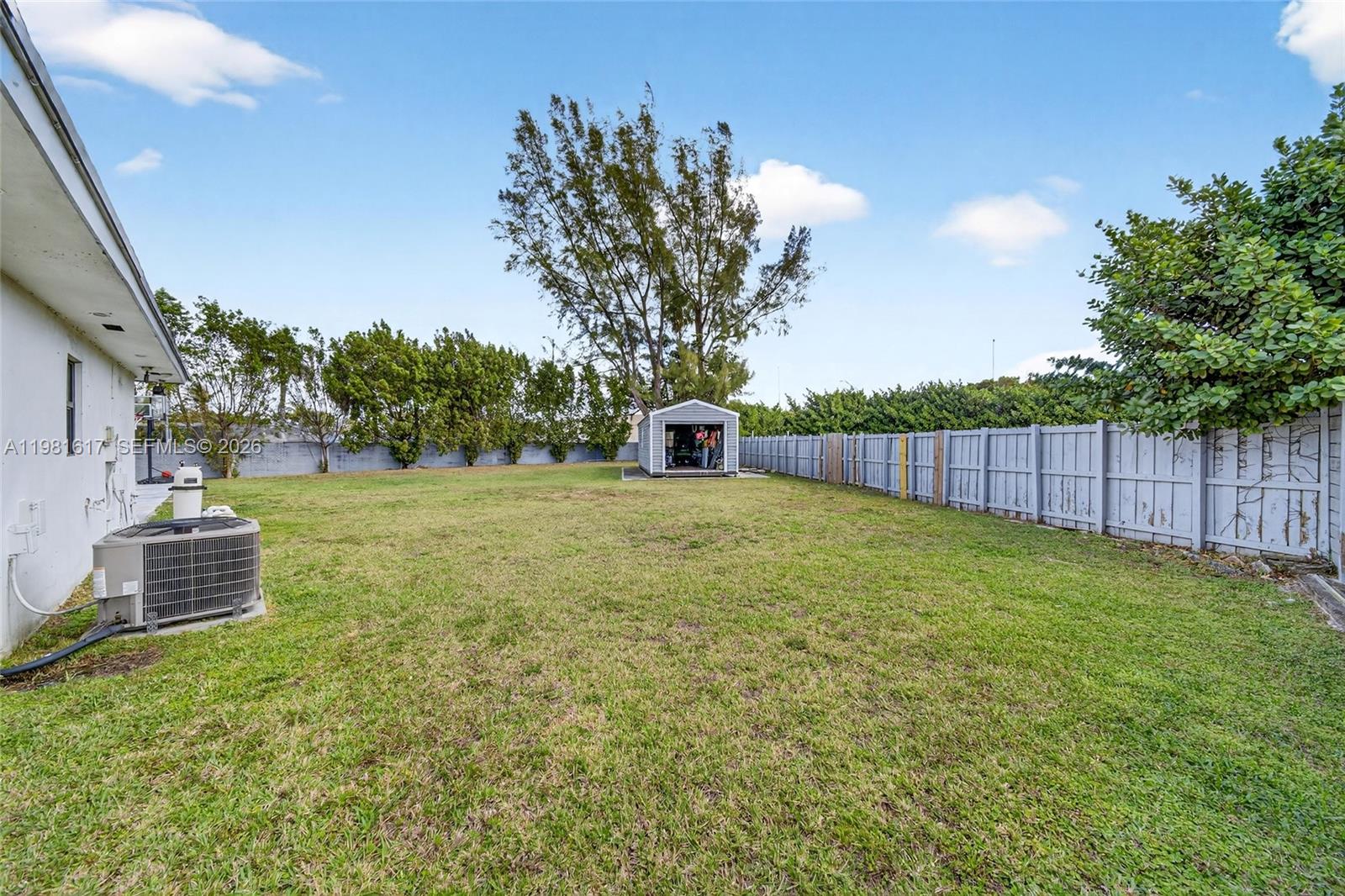 11951 Southwest 120th Terrace Miami, FL 33186 - Photo 54 of 55 a view of a backyard with large trees