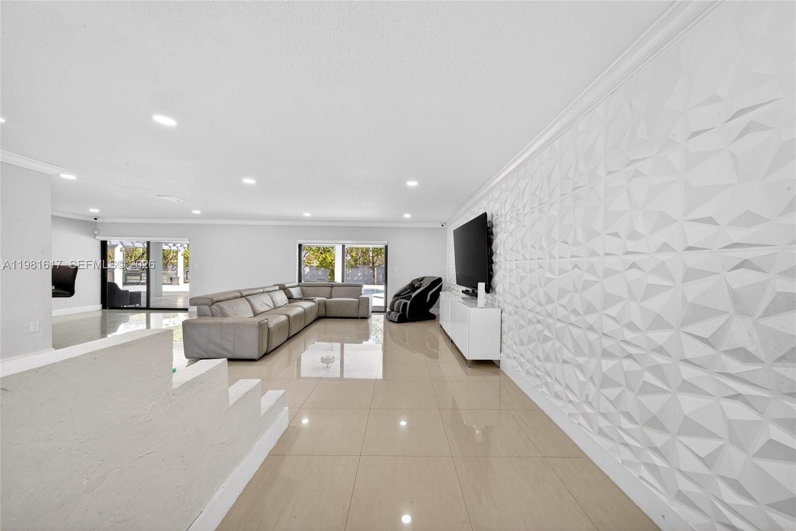 11951 Southwest 120th Terrace Miami, FL 33186 - Photo 10 of 55 a living room with couches and a flat screen tv