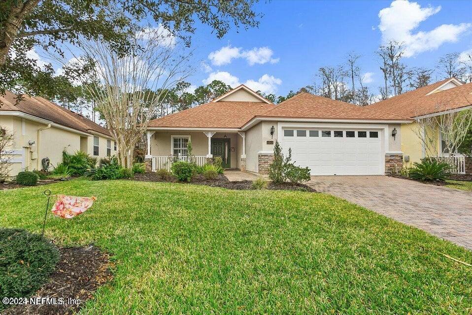 1212 Coghill Circle St. Augustine, FL 32092 - Photo 1 of 18 a front view of a house with a yard
