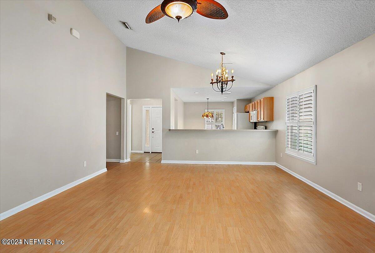 1212 Coghill Circle St. Augustine, FL 32092 - Photo 4 of 18 a view of a kitchen with wooden floor and a window