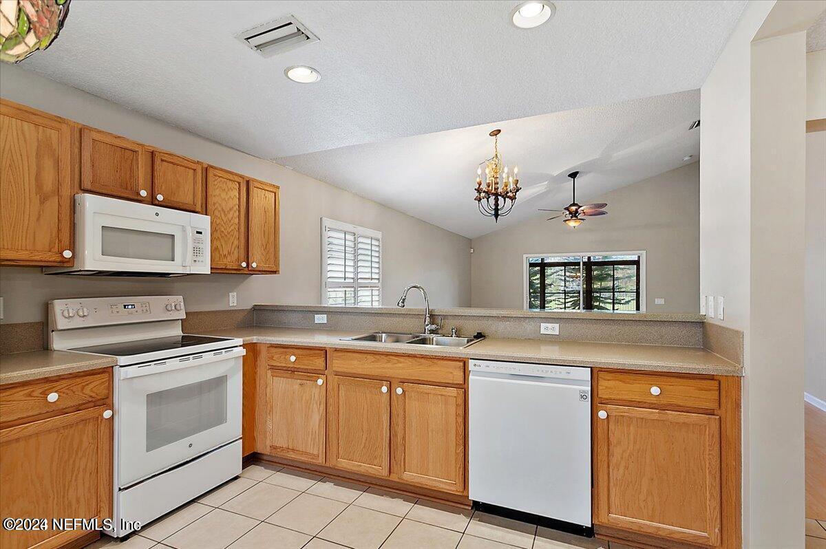 1212 Coghill Circle St. Augustine, FL 32092 - Photo 5 of 18 a kitchen with a sink stove and microwave