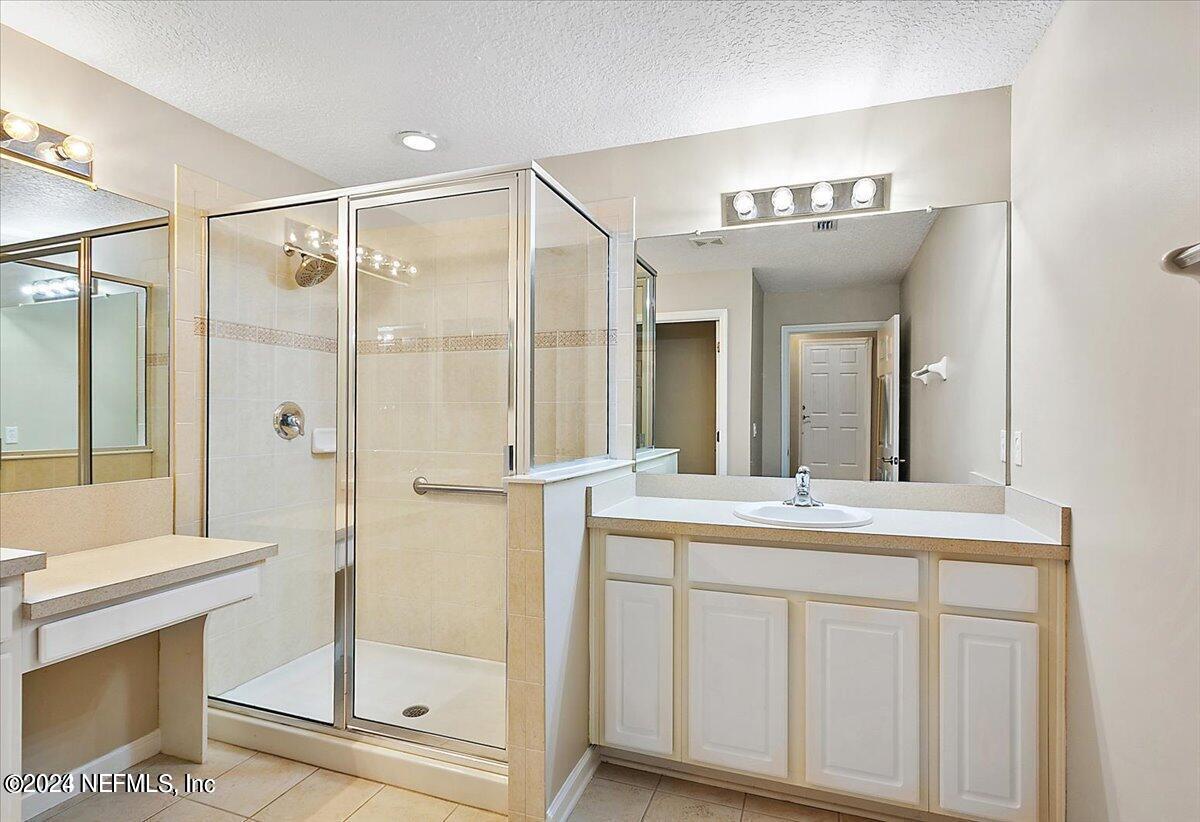 1212 Coghill Circle St. Augustine, FL 32092 - Photo 9 of 18 a bathroom with a double vanity sink mirror and shower