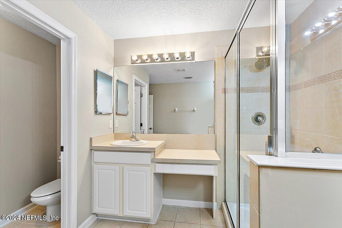 1212 Coghill Circle St. Augustine, FL 32092 - Photo 10 of 18 a bathroom with a double vanity sink mirror and toilet