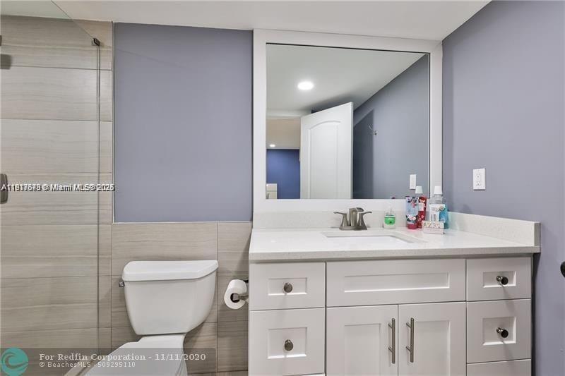 3100 Riverside Drive, Unit 107 Coral Springs, FL 33065 - Photo 21 of 33 a bathroom with a sink toilet and mirror