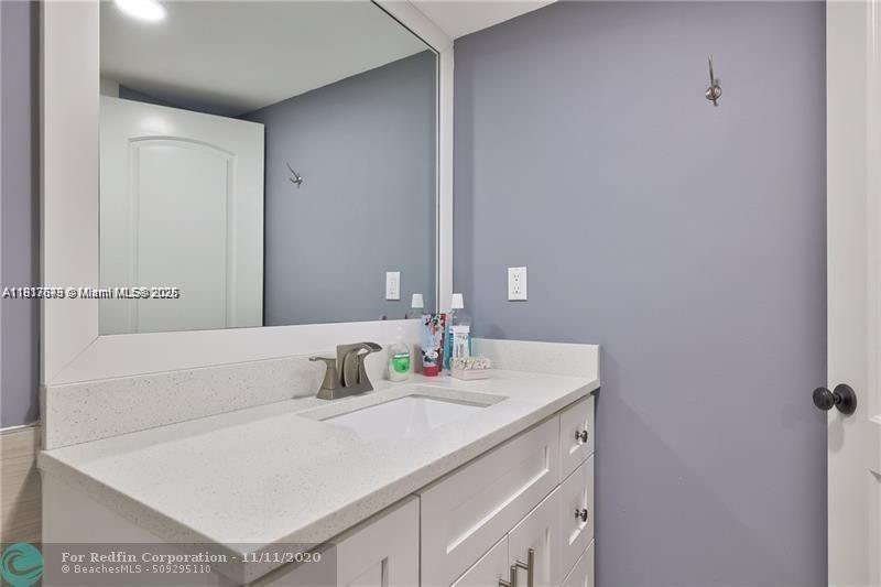 3100 Riverside Drive, Unit 107 Coral Springs, FL 33065 - Photo 23 of 33 a bathroom with a sink and a mirror